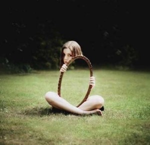 very creative mirror reflection of the grass making the girl in photo like disappeared