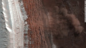 An image captured in 2008 by NASA's Mars Reconnaissance Orbiter shows at least four Martian avalanches, or debris falls, taking place. Material, likely including fine-grained ice and dust and possibly large blocks, detached from a towering cliff and cascaded to the gentler slopes below.