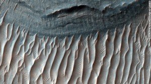 This 2008 image spans the floor of Ius Chasma's southern trench in the western region of Valles Marineris, the solar system's largest canyon. Ius Chasma is believed to have been shaped by a process called sapping, in which water seeped from the layers of the cliffs and evaporated before it reached the canyon floor.